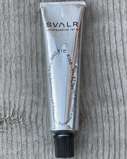 Svalr lip balm tube on a wooden surface