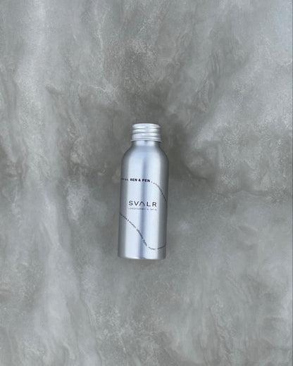 Silver bottle with 'SVALR' branding on a textured gray background